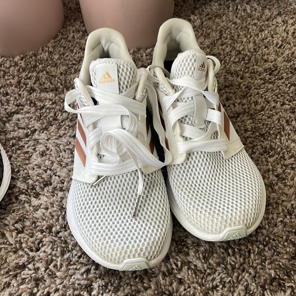 White athletic adidas shoes